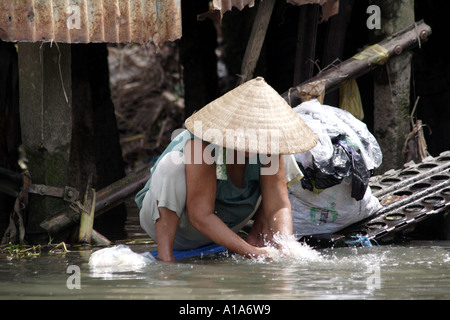 Woman washing clothes in the Mekong Delta, Vietnam Stock Photo