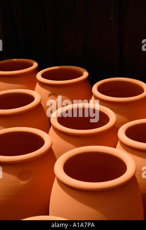 Large terracotta earthenware pots stacked in the sun Morris James pottery Matakana New Zealand Stock Photo