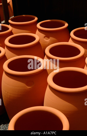 Large terracotta earthenware pots stacked in the sun Morris James pottery Matakana New Zealand Stock Photo