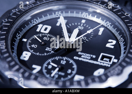 A chronograph shows five minutes before twelve, symbol for date, deadline, term Stock Photo