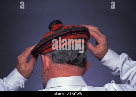 Man wearing knit wool orange and green Tam O Shanter Stock Photo