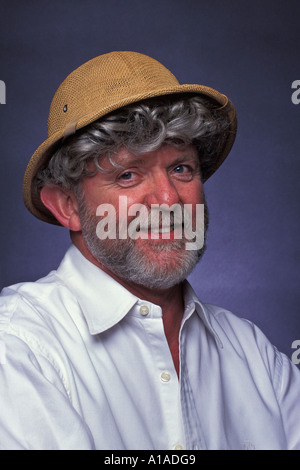 Man with grey beard and grey curly hair wearing safari helmet Stock Photo