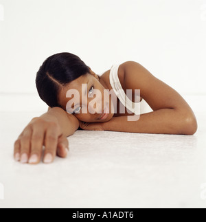 Young woman lying down and reaching out Stock Photo