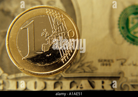 One euro coin against a us one dollar bill banknote Stock Photo