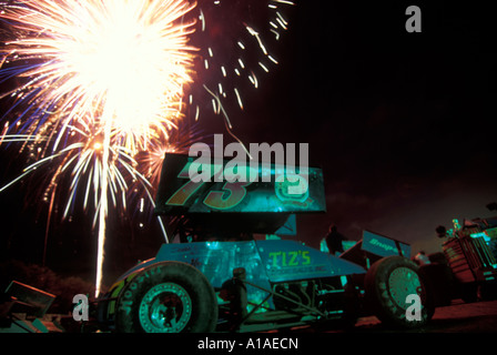 USA Washington Sedro Wooley 4th of July fireworks fill night sky over sprint cars in pits at Skagit Speedway Stock Photo