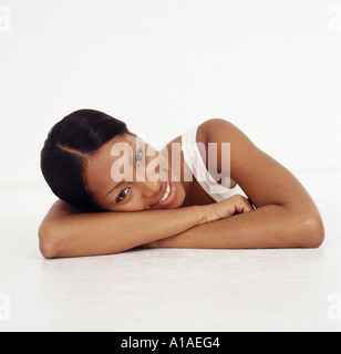 Young woman resting her head on her arms Stock Photo