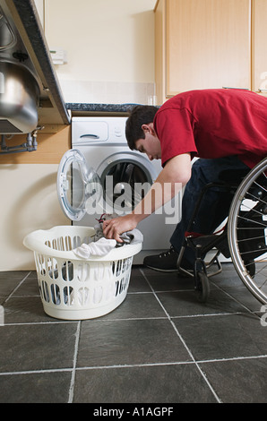 Disabled man doing laundry Stock Photo