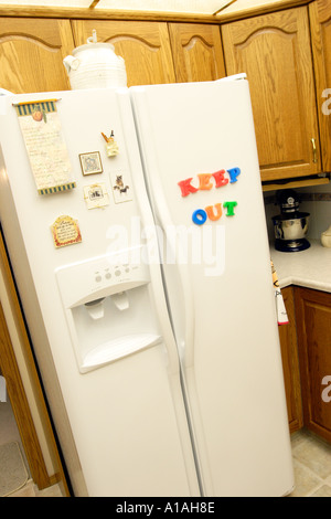 Refridgerator with magnetic letters spelling Keep Out Stock Photo