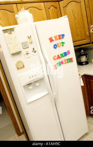 Refridgerator with magnetic letters spelling Keep out carbs inside Stock Photo