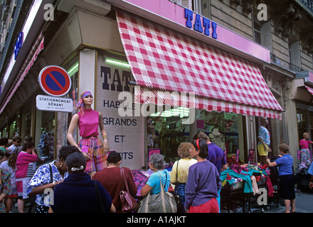 Shop selling colourful cheap clothes on stalls in the streets of Montmartre district of Paris Stock Photo