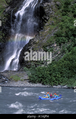 USA Alaska Chugach National Forest Whitewater rafters paddle past Bridal Veil Falls in Keystone Canyon near Valdez Stock Photo