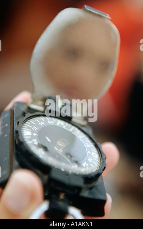 Close-up of person holding compass Stock Photo