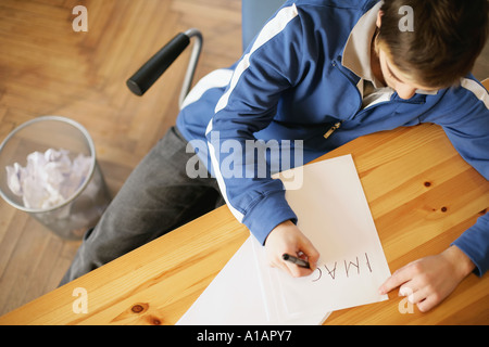 Man writing a word on paper Stock Photo