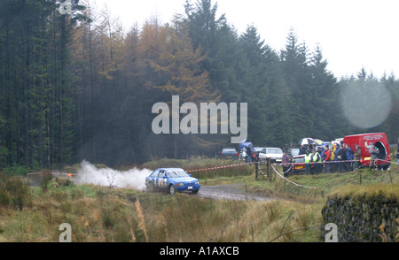 Ford Escort rally car spews out smoke during the forest stages of the Toshiba Rally Ballypatrick Forest County Antrim Stock Photo
