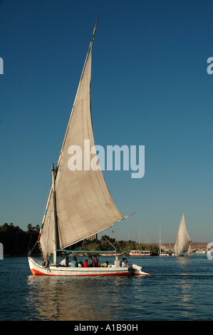 Traditional Felucca boat sailing in the Nile river between Aswan and Luxor Egypt Stock Photo