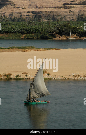 A felucca traditional wooden sailing boat on the Nile river between Aswan and Luxor Egypt Stock Photo