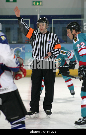 Ice Hockey referee calling the players in for a face off Stock Photo