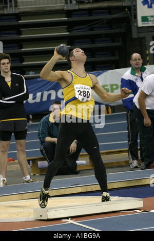 Shot put competitor throws the shot at the Irish Indoor Athletics meeting at the Odyssey Arena Belfast Northern Ireland Stock Photo