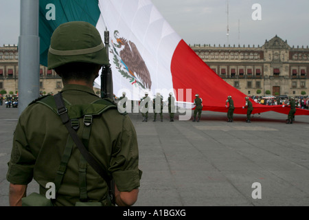 A soldier stands guard during the daily lowering of the flag in the Zocalo of Mexico City, Mexico. Stock Photo