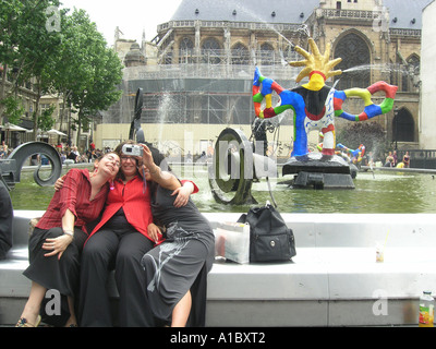 image no 1 of three female students taking digital picture in front of Tinguely fountain at Place Igor Stravinsky Paris Franc Stock Photo