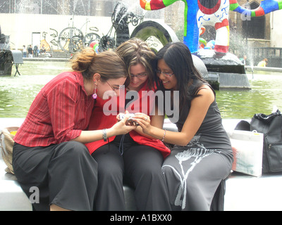 image no 3 of three female students taking digital picture in front of Tinguely fountain at Place Igor Stravinsky Paris France Stock Photo