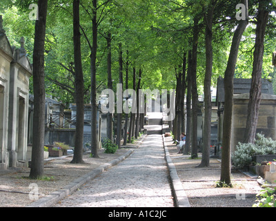 tree lined lane at Pere Lachaise cemetery Paris France Stock Photo