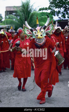 Costumed devil dancers parade through streets during annual Corpus Christi Day celebration in San Francisco de Yare Venezuela Stock Photo