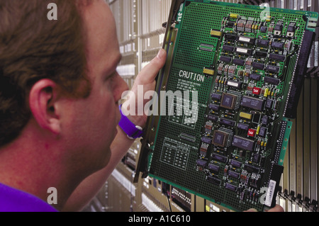 An MCI Corporation technician checks a cicuit board in a new telephone switch in Baltimore Maryland Stock Photo