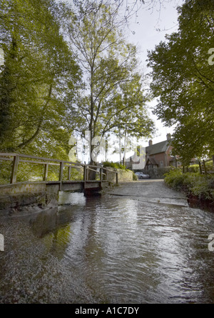 Ford in Shere village in Surrey, England, UK, with a footbridge over ...