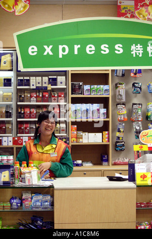 big smile on an attendant at a convenience store in Guangzhou, China Stock Photo