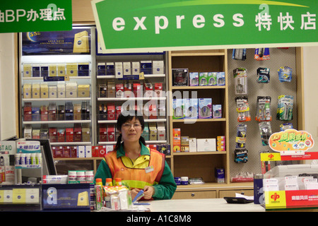 attendant at a convenience store in Guangzhou, China Stock Photo