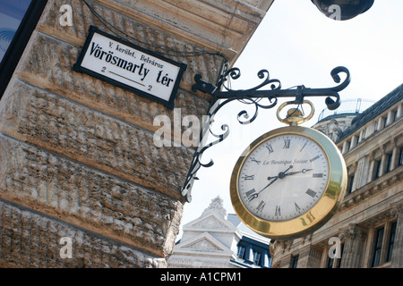 Clock in the shape of a pocketwatch on a shop in Budapest Hungary Stock Photo