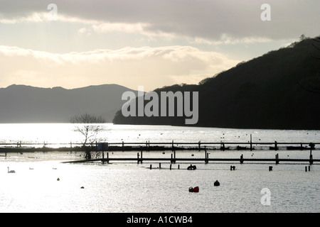 View into sun across Loch Lomond from Balmaha harbour Stock Photo