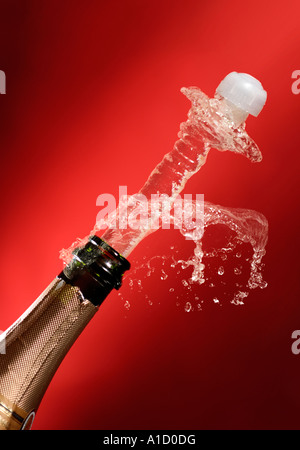 Bottle of Champagne with flying away cork Christmas celebration holiday concept Stock Photo
