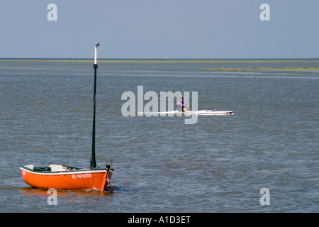 Man on an outrigger canoe in tidal estuary of River Somme St Valery sur Somme Somme Picardy Stock Photo