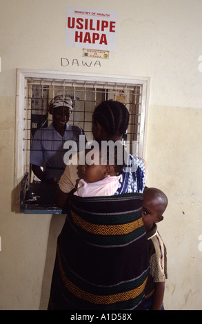 Mombassa,Kenya. Mother collecting medecines at pharmacy counter Stock Photo