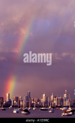 A dusk rainbow cast across the Melbourne City skyline from Williamstown waterfront Stock Photo