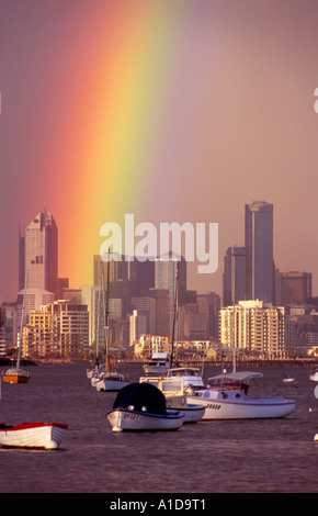 A dusk rainbow cast across the Melbourne City skyline from Williamstown waterfront Stock Photo