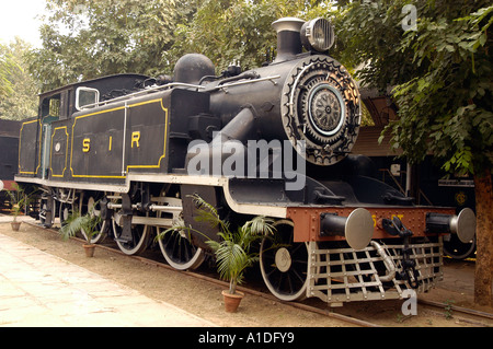 Steam Locomotive PT 11: A British-built engine used in India, featuring black livery and white-rimmed wheels at a museum display. Stock Photo