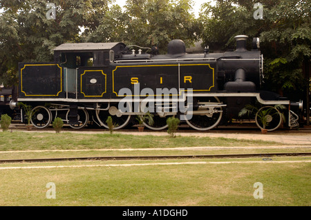 Steam Locomotive PT 11, built in Britain and used in India, displayed on tracks with black paint and yellow trim. Stock Photo