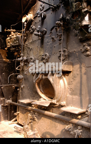 Steam Locomotive PT 11, British-built engine used in India. Detailed view of the vintage industrial firebox, controls, and mechanical components. Stock Photo