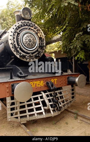 Front view of Steam Locomotive PT 11, built in Britain and used in India, featuring an ornate boiler door, buffers, and a metal cowcatcher. Stock Photo