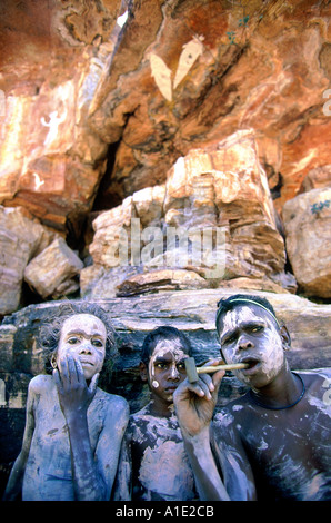 Aboriginal Rembargna clan boys paint up with white pipe clay when visiting significant sacred site Dukuladjarranj Arnhem land Stock Photo