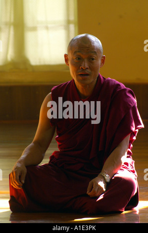 Meditating sitting buddhist tibetan monk in traditional ceremonial robe ...