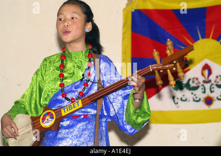 Young girl singer performer of tibetan arts music in front of national flag of tibet Stock Photo