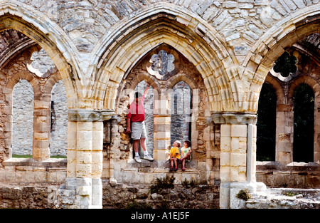 Dad and small kids visit ruins of old Abbey in Hampshire UK Stock Photo