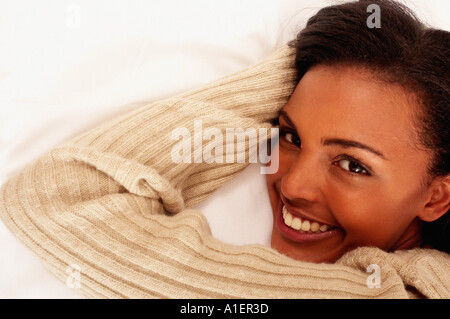 Smiling young woman lying down Stock Photo
