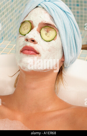 Young woman having facial in bath