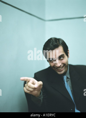 Businessman smiling and pointing Stock Photo