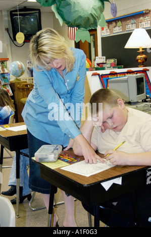 Pregnant woman teacher conducts lessons in her third grade classroom Stock Photo